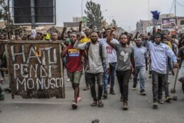 Residents protest against the United Nations peacekeeping force (MONUSCO) deployed in the Democratic Republic of the Congo in Goma Tuesday July 26, 2022. Demonstrators said they were protesting against the rise of insecurity and inaction of the UN in the region. The sign left reads: "Monusco no more" (AP Photo/Moses Sawasawa)