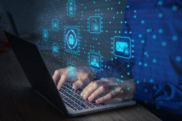 person ketying info into laptop