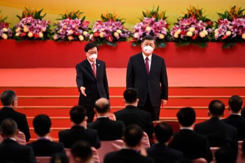 Hong Kong lawmaker photographed with Xi tests positive for COVID