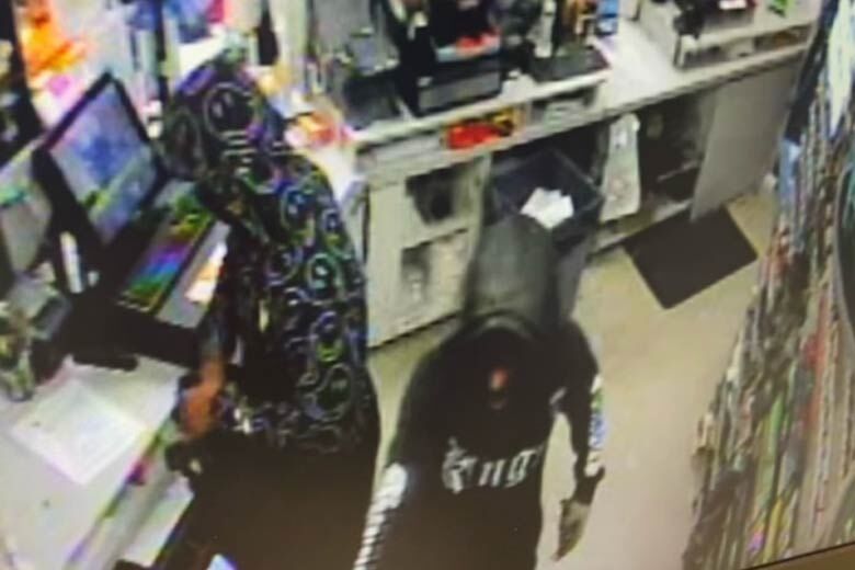 Pair of suspects robbing a gas station