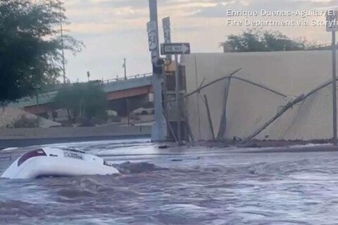 Woman rescued moments before car swallowed by sinkhole