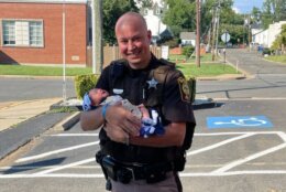 Baby and mother stopped by the Fauquier County Sheriff’s Office yesterday for an official introduction to Deputies Zachary Lawrence and John Clubb. (Courtesy Fauquier Co. Sheriff's Office via Facebook)