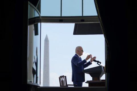 Still isolating, Biden signs anti-fraud pandemic bills