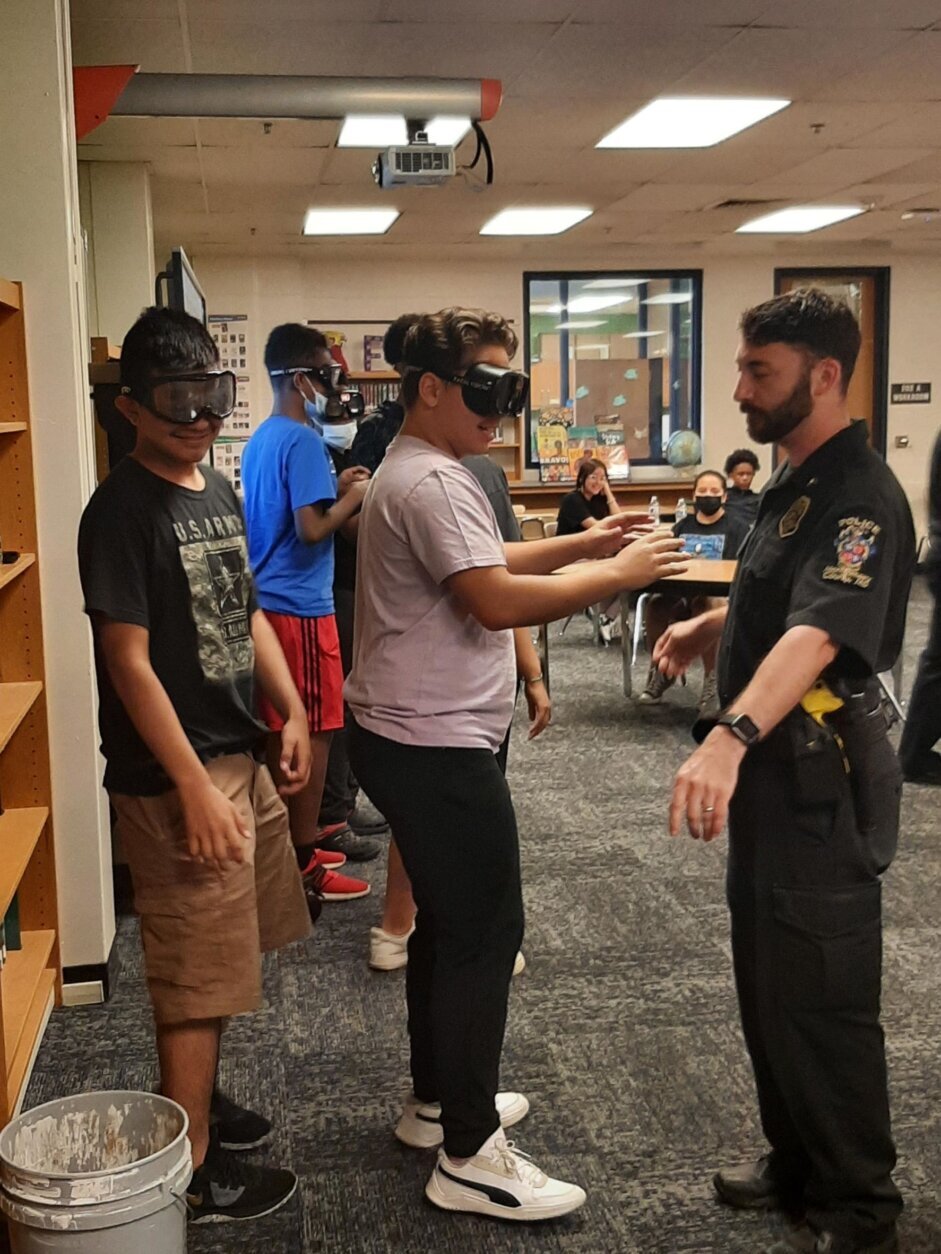 Officers engage with students at the Back to School Jam in Summer of 2021. (Courtesy Montgomery County Police/Public Schools)
