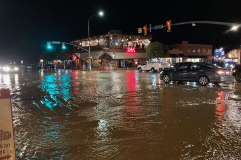 Arizona levee breached, hiker missing after floods hit West