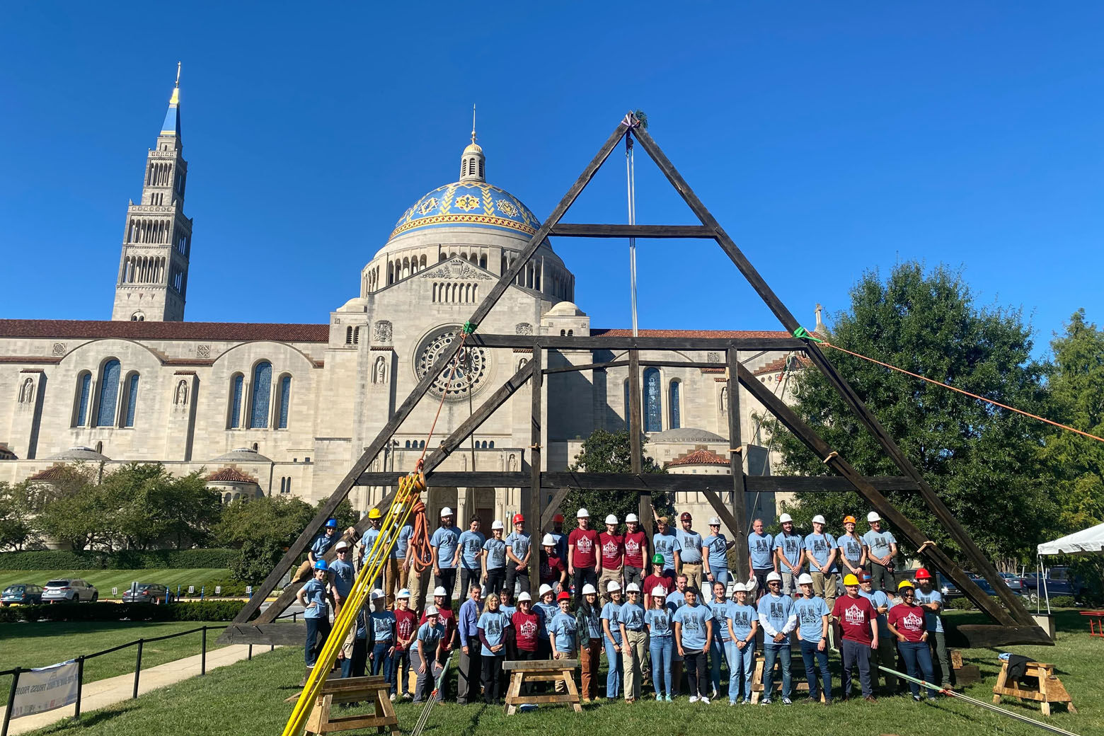 A group of Catholic university students raised a three-story replica roof truss in front of the Basilica of the National Shrine of the Immaculate Conception Monday. (WTOP/Luke Lukert)