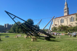 A group of Catholic university students raised a three-story replica roof truss in front of the Basilica of the National Shrine of the Immaculate Conception Monday. (WTOP/Luke Lukert)