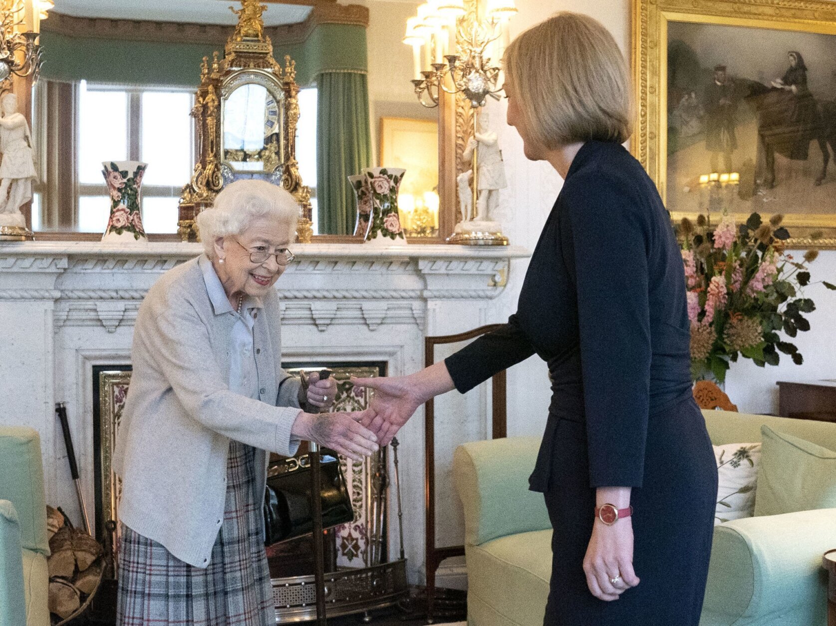 Britain's Queen Elizabeth II, left, welcomes Liz Truss during an audience at Balmoral, Scotland, where she invited the newly elected leader of the Conservative party to become Prime Minister and form a new government, Tuesday, Sept. 6, 2022. (Jane Barlow/Pool Photo via AP)