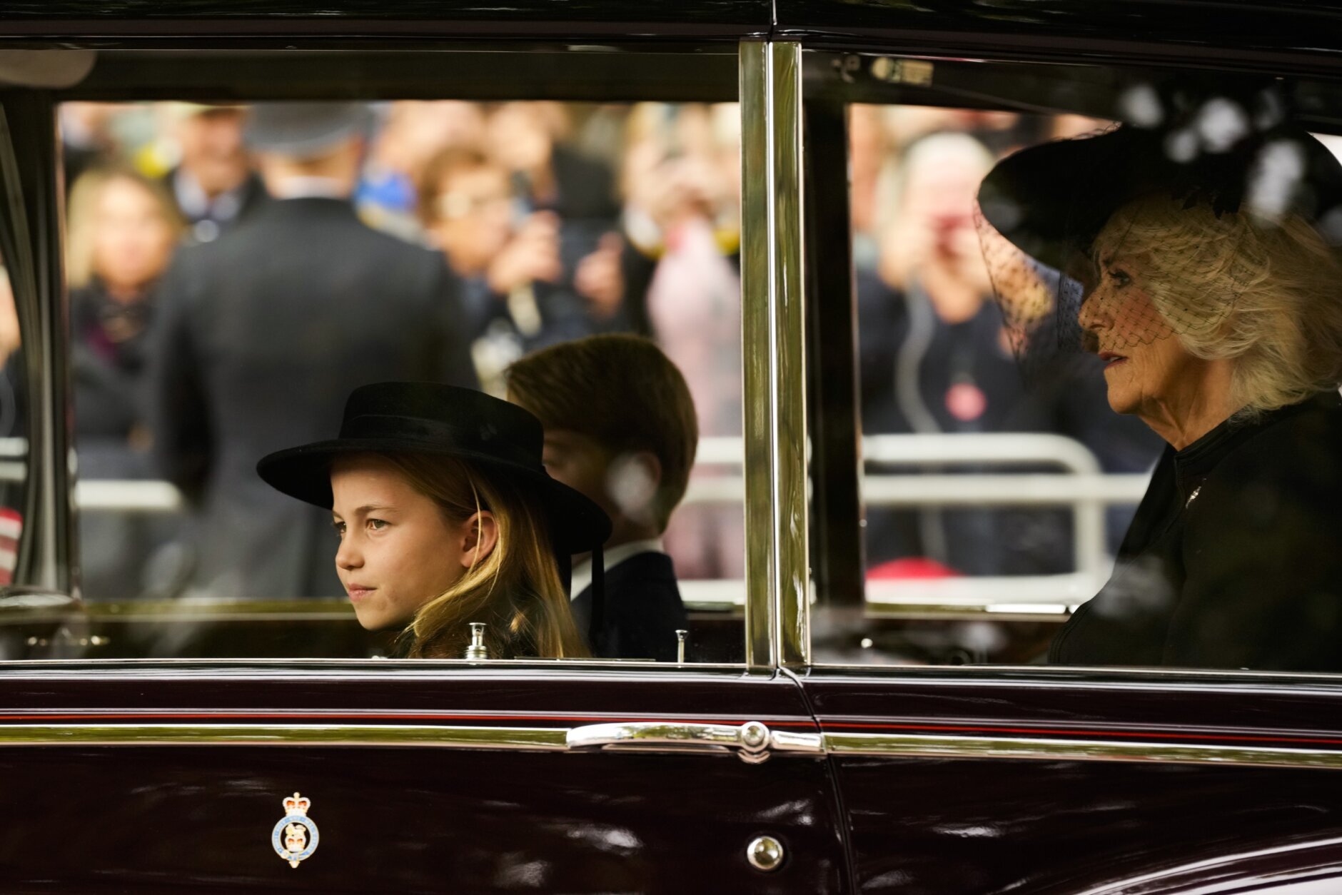 Britain's Prince Charlotte, left, Prince George, background, and Camilla, the Queen Consort, right, arrive by car ahead of the Queen Elizabeth II funeral in central London, Monday, Sept. 19, 2022. The Queen, who died aged 96 on Sept. 8, will be buried at Windsor alongside her late husband, Prince Philip, who died last year. (AP Photo/Andreea Alexandru, Pool)