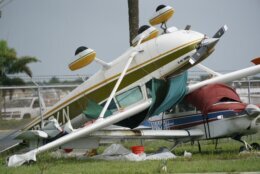 An airplane overturned by a likely tornado produced by the outer bands of Hurricane Ian is shown, Wednesday, Sept. 28, 2022, at North Perry Airport in Pembroke Pines, Fla. Hurricane Ian rapidly intensified as it neared landfall along Florida's southwest coast Wednesday morning, gaining top winds of 155 mph (250 kph), just shy of the most dangerous Category 5 status. (AP Photo/Wilfredo Lee)