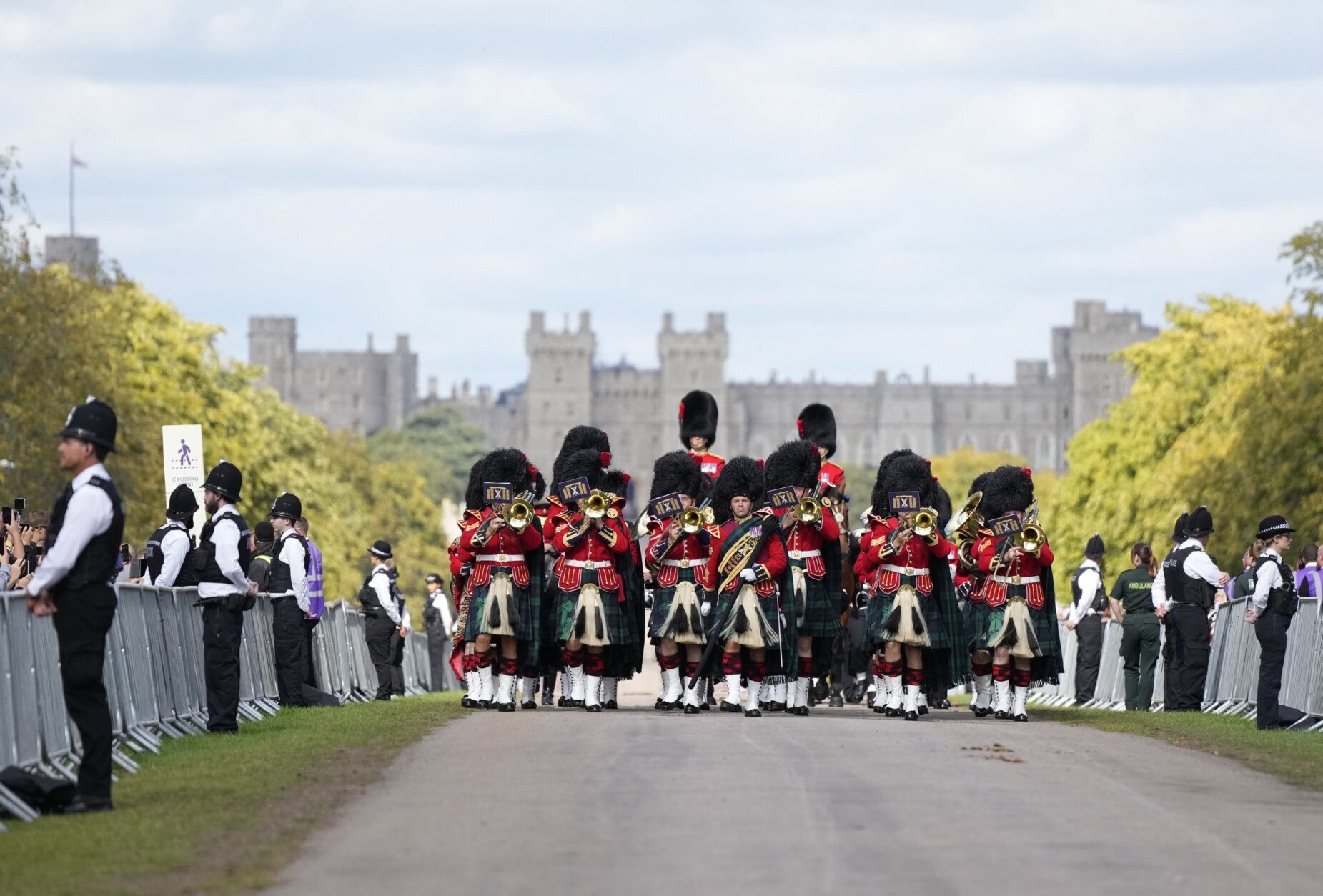The Band of the Royal Regiment of Scotland plays ahead of the arrival of the coffin of Queen Elizabeth II outside Windsor Castle in Windsor, England, Monday, Sept. 19, 2022. The Queen, who died aged 96 on Sept. 8, will be buried at Windsor alongside her late husband, Prince Philip, who died last year. (AP Photo/Alastair Grant, Pool)