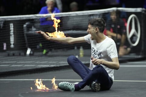 Laver Cup protester sets court, arm on fire, delays match
