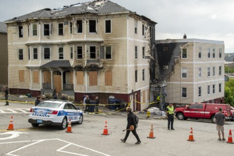 Woman charged with setting fire at apartment that killed 4