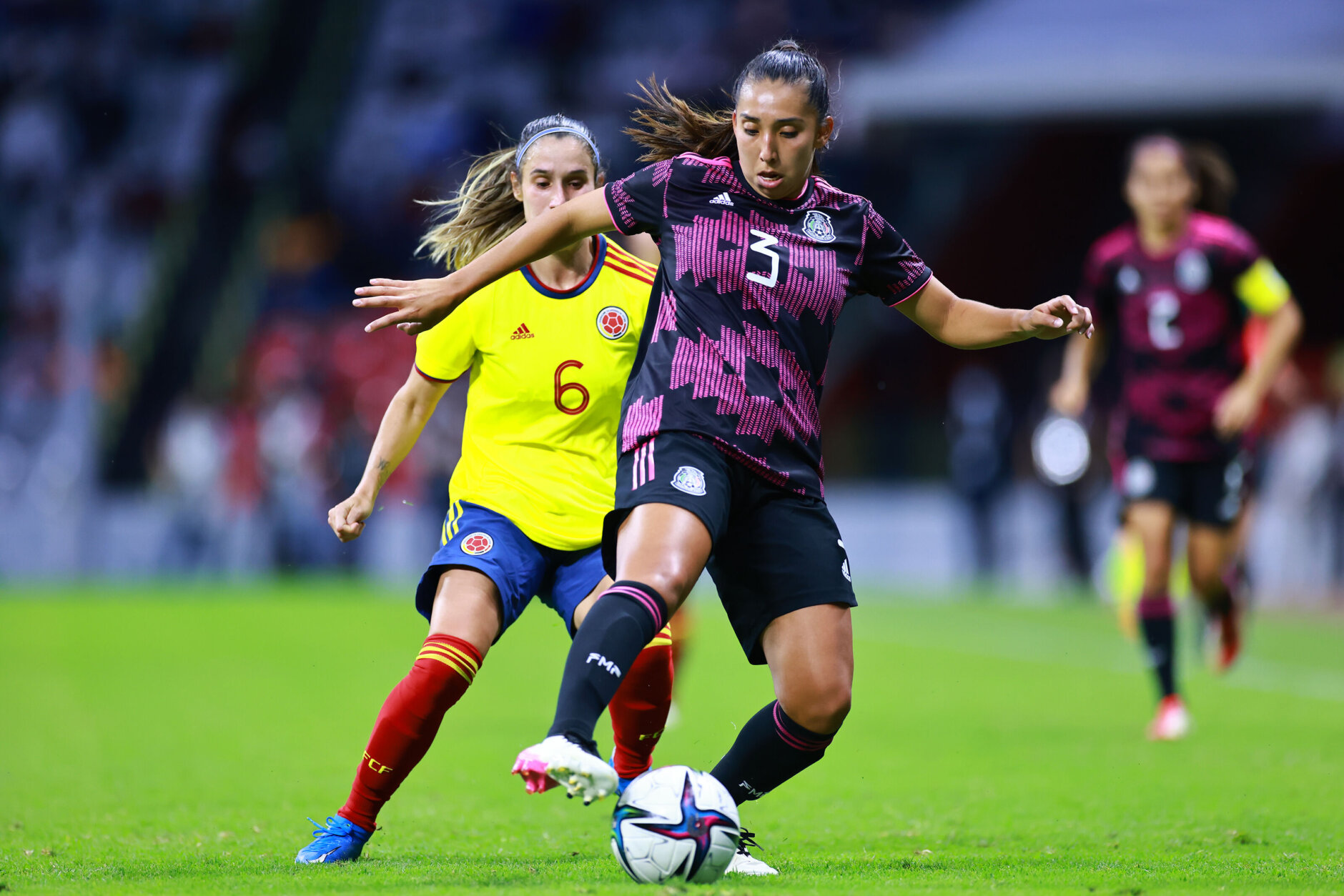MEXICO CITY, MEXICO - SEPTEMBER 21: Karina Rodriguez of Mexico battles for possesion with Daniela Montoya of Colombia during the women's international friendly between Mexico and Colombia at Azteca Stadium on September 21, 2021 in Mexico City, Mexico. (Photo by Hector Vivas/Getty Images)