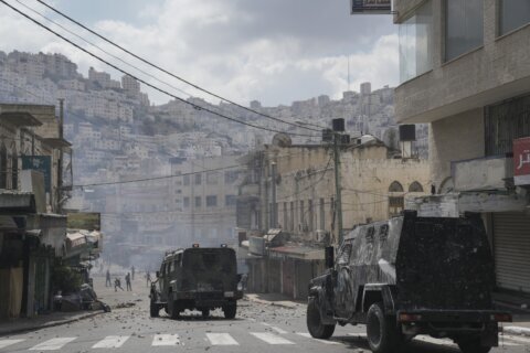 Palestinian forces clash with gunmen; woman killed in Israel