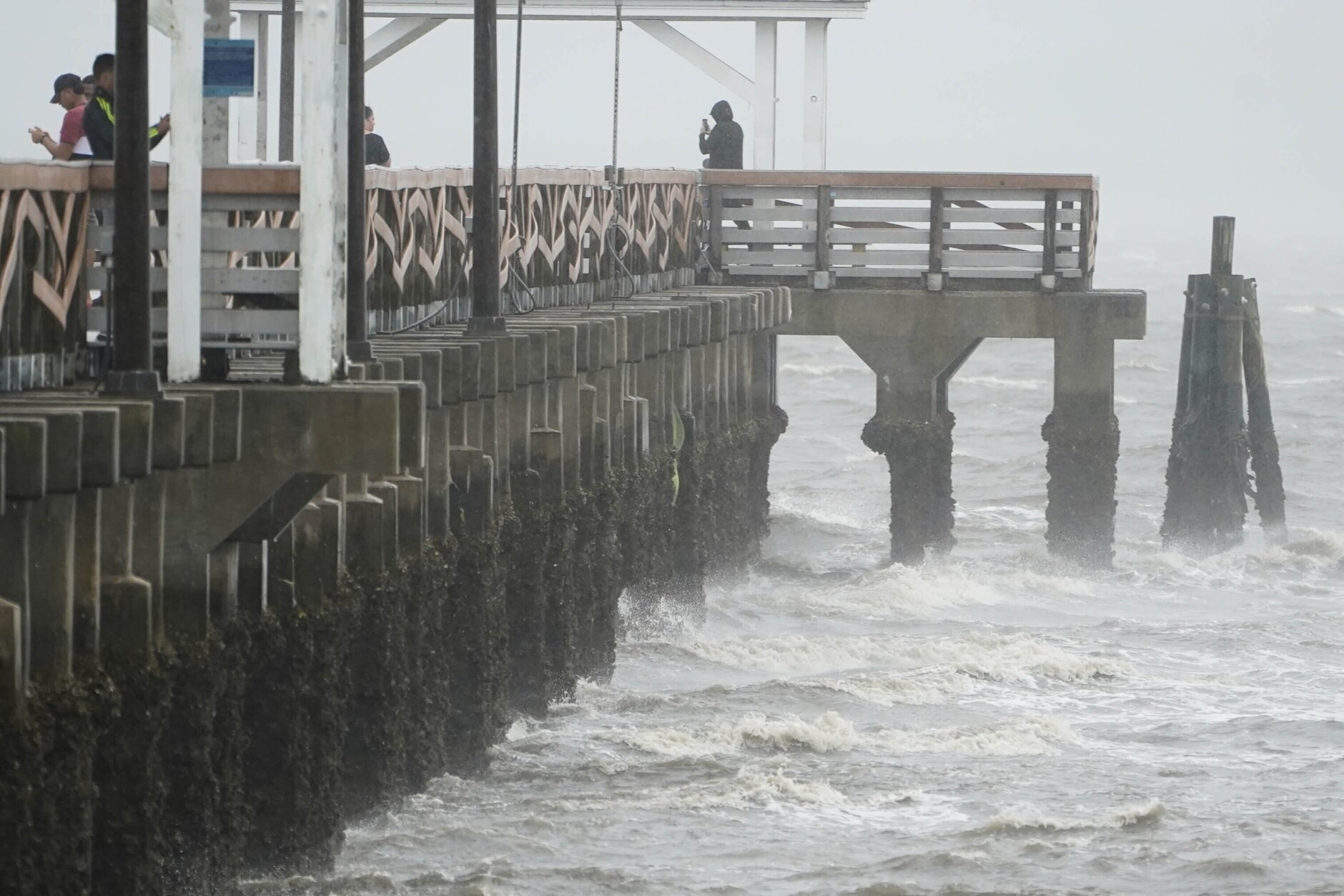 Waves crash along the Ballast Point Pier ahead of Hurricane Ian, Wednesday, Sept. 28, 2022, in Tampa, Fla. The U.S. National Hurricane Center says Ian's most damaging winds have begun hitting Florida's southwest coast as the storm approaches landfall.   (AP Photo/Chris O'Meara)