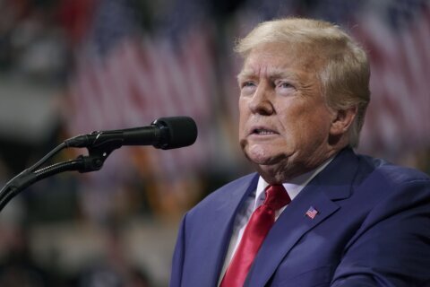 Trump signals affinity with QAnon followers in social media post, at rallies