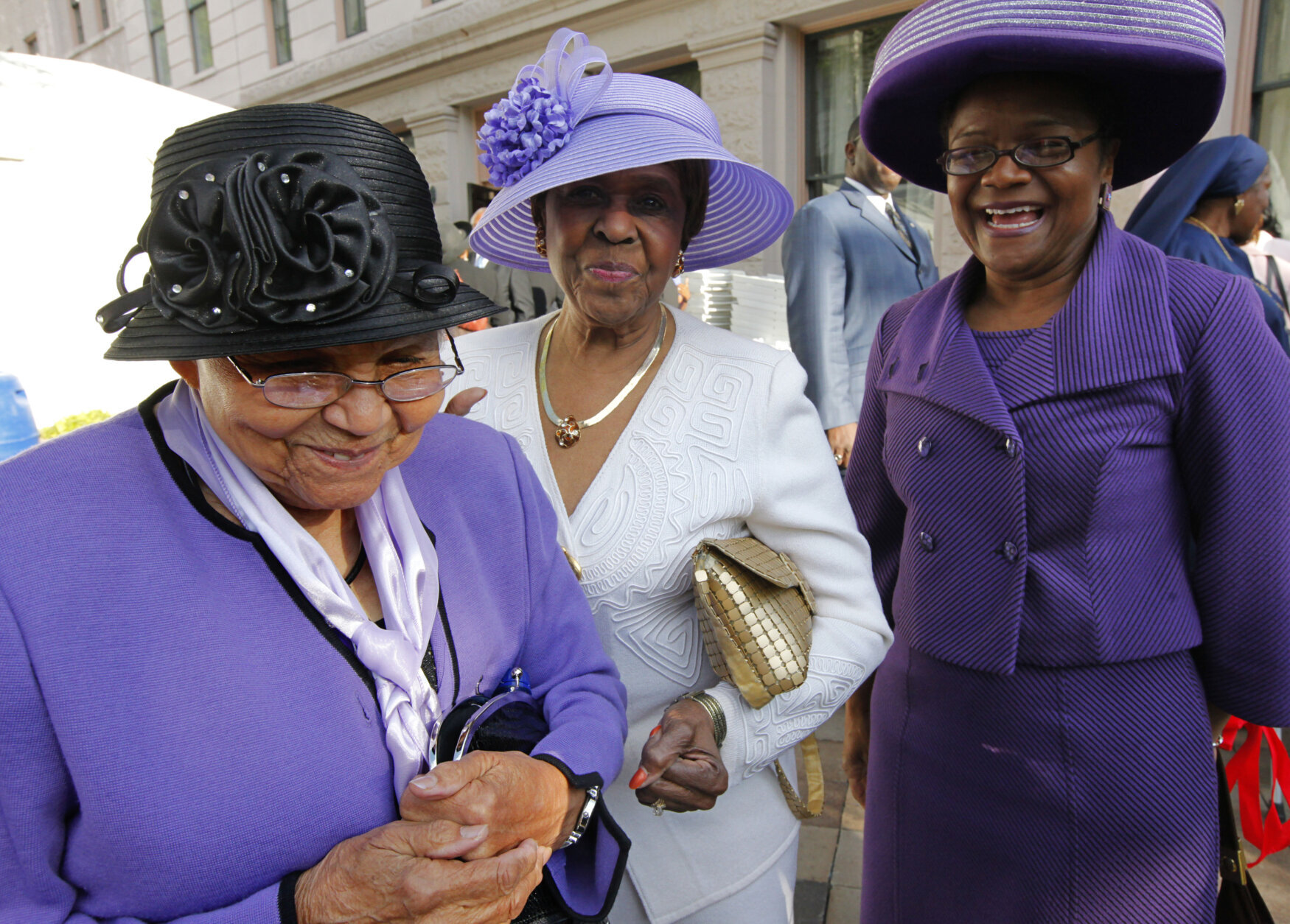 In this April 27, 2010, file photo milliner Vanilla P. Beane, 90, left, talks about her friendship with the late Dorothy Height, the leading female voice of the 1960s civil rights movement, outside the National Council of Negro Women building in Washington, where Height's casket arrived for public viewing.  When Height died at age 98 this spring, some of her friends and admirers wore hats to her funeral as a final tribute, Beane among them. And many of the women also wore purple, Height's favorite color.  (AP Photo/J. Scott Applewhite, File)