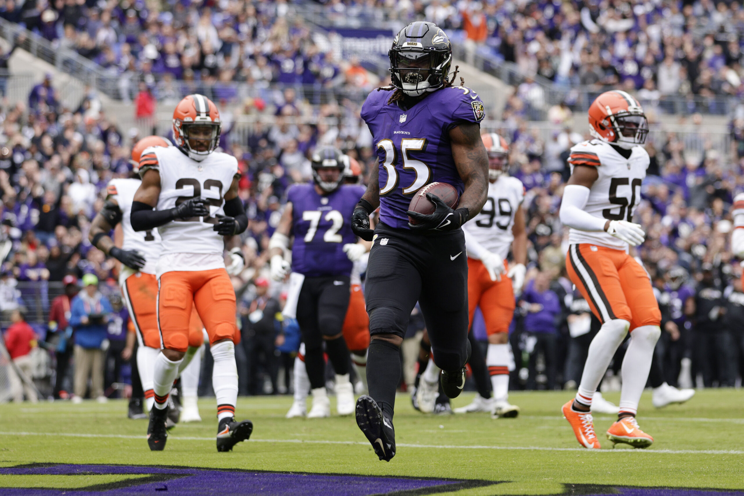 Baltimore Ravens running back Gus Edwards runs with the ball