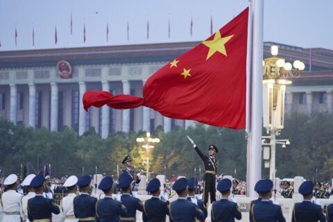 AP PHOTOS: China marks National Day with flag-raising, toast