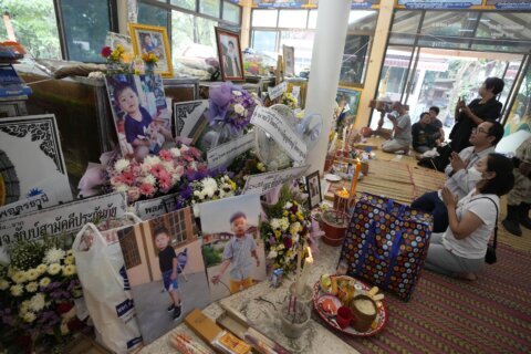 Mourners pray at Thai temple filled by children’s keepsakes