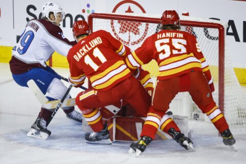 Flames beat Avs 5-3 to win opener for first time since 2009
