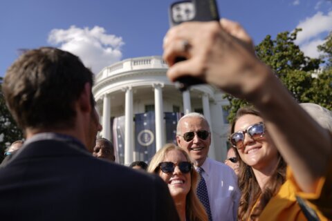 One hug and one selfie at a time, Biden's mission to connect