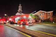 a church with emergency vehicles in front at night