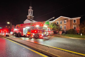 a church with emergency vehicles in front at night