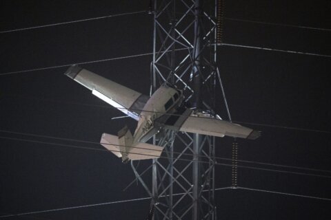 Plane caught in power lines after crash, 2 occupants unhurt