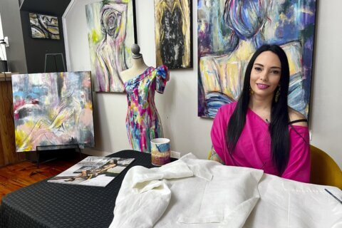 Artist’s hand-painted dress to match her work goes viral