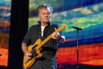 musician John Mellencamp playing guitar