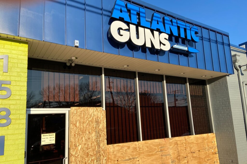 Atlantic Guns was open for business again after the robbery early Friday. But wood panels covered much of the store’s facade.