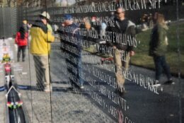 Visitors, volunteers at the Vietnam Veterans Memorial.