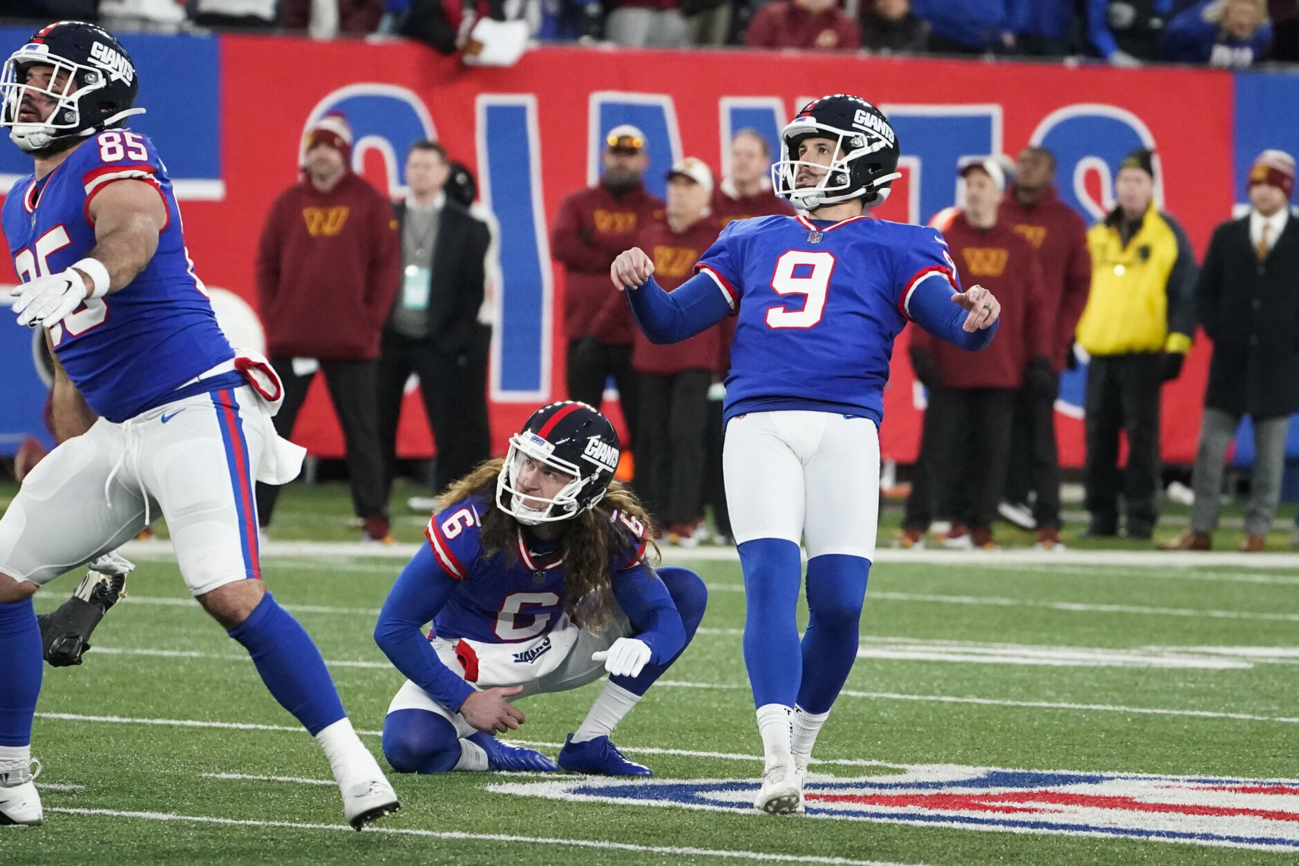 New York Giants kicker Graham Gano, right, looks after his field goal during overtime of an NFL football game against the Washington Commanders, Sunday, Dec. 4, 2022, in East Rutherford, N.J. The kick missed and the game ended in a tie. (AP Photo/John Minchillo)