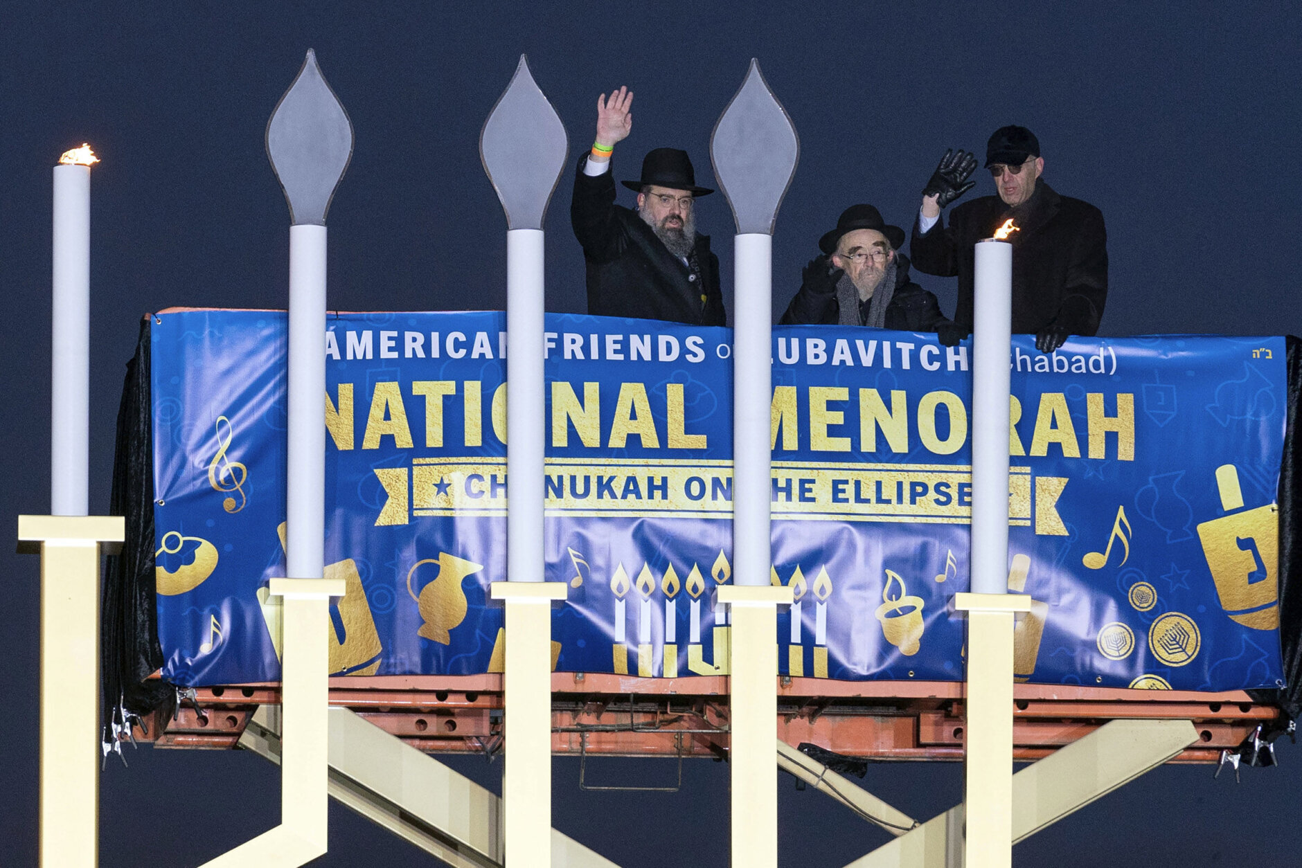 From left, Rabbi Levi Shemtov, Rabbi Abraham Shemtov and Attorney General Merrick Garland participate in the annual National Menorah Lighting in celebration of Hanukkah, on the Ellipse near the White House in Washington, Sunday, Dec. 18, 2022. (AP Photo/Jose Luis Magana)