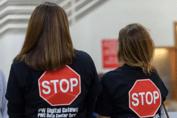 Opponents outside the Prince William Board of County Supervisors meeting ahead of a public hearing and vote on the PW Digital Gateway project.