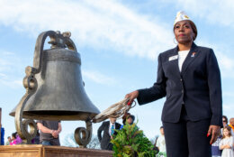 U.S. Marine Corps Veteran Tweila-Rochelle Cauthen rings the 1863 bell on the steps of the Lincoln Memorial during the 2023 National Bell Festival.