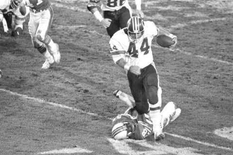 WHEN 70 CHIP BECAME A HOUSEHOLD TERM IN DC - In this Jan. 30, 1983, file photo, Washington legend John Riggins (44) breaks away from Miami Dolphins cornerback Don McNeal on his way to the winning touchdown in fourth-quarter of Super Bowl XVII in Pasadena, Ca. Washington turned into a run-heavy offense in the second half and that led to Riggins’ memorable run off left tackle against a tiring Miami defense. (AP Photo, File)
