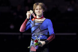 Ilia Malinin holds his medal after the men's free skate at the U.S. figure skating championships in San Jose, Calif., Sunday, Jan. 29, 2023. Malinin finished first in the event. (AP Photo/Tony Avelar)