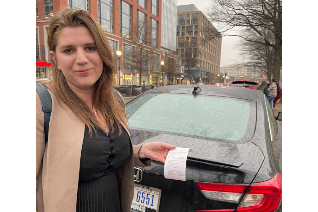Alexa Jaenicke holds her $100 ticket that she got on the 800 block of Maine Avenue.
