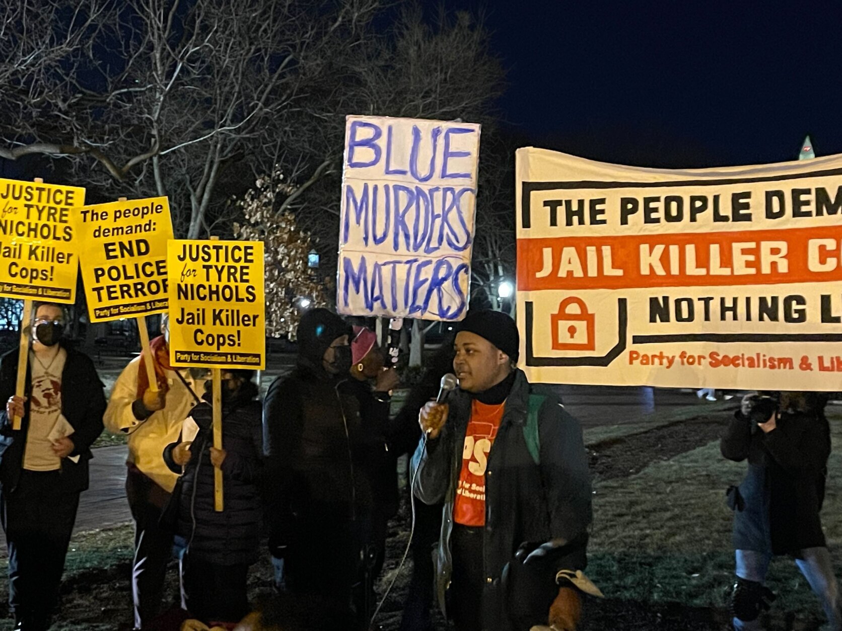 The Party for Socialism and Liberation protesters in downtown D.C. holding signs that read "The people demand: Jail Killer Cops; Nothing Less!"