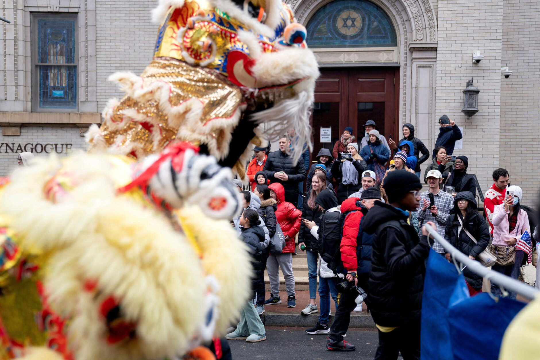Onlookers watch the Lunar New Year Parade in the Chinatown neighborhood of Washington, DC, on January 22, 2023. - 2023 is the year of the rabbit in the Chinese horoscope. (Photo by Stefani Reynolds / AFP) (Photo by STEFANI REYNOLDS/AFP via Getty Images)