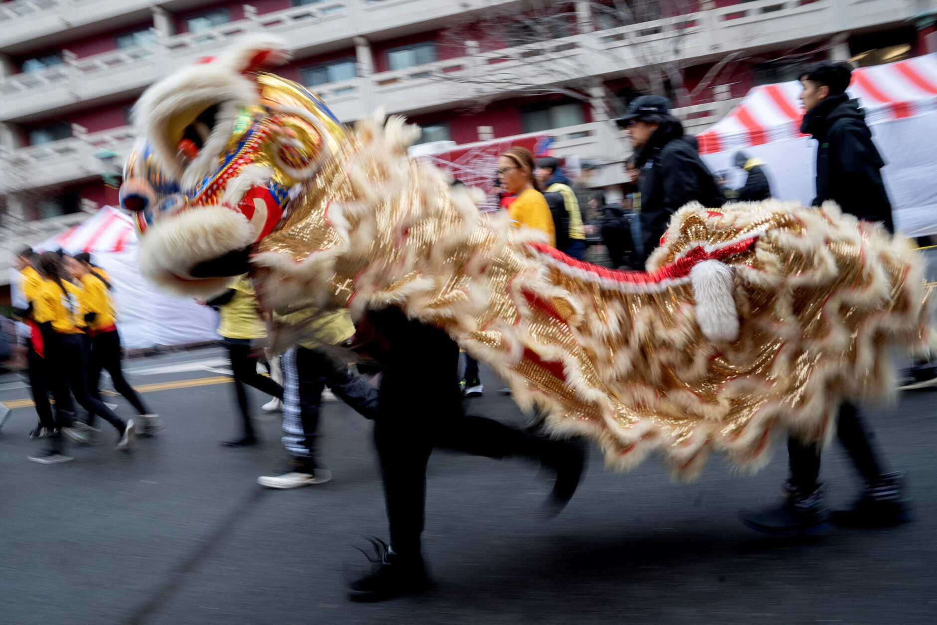 Participants dance ahead of the Lunar New Year Parade in the Chinatown neighborhood of Washington, DC, on January 22, 2023. - 2023 is the year of the rabbit in the Chinese horoscope. (Photo by Stefani Reynolds / AFP) (Photo by STEFANI REYNOLDS/AFP via Getty Images)