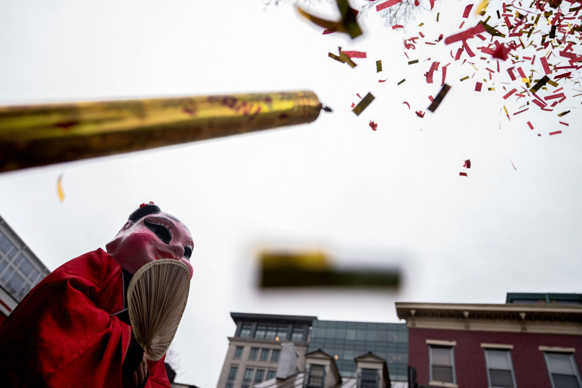 Confetti flies over a performer following the Lunar New Year Parade in the Chinatown neighborhood of Washington, DC, on January 22, 2023. - 2023 is the year of the rabbit in the Chinese horoscope. (Photo by Stefani Reynolds / AFP) (Photo by STEFANI REYNOLDS/AFP via Getty Images)