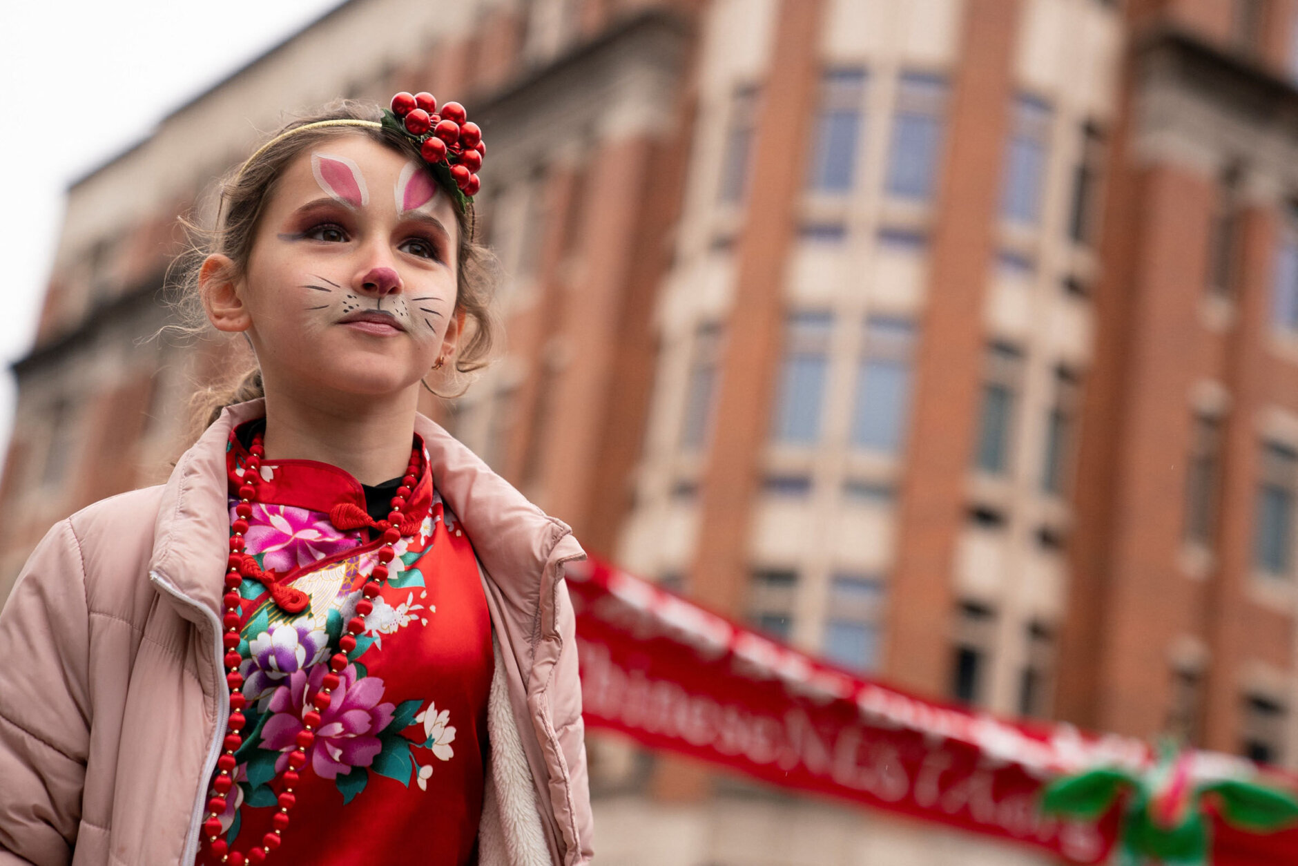 A child marches in the Lunar New Year Parade in the Chinatown neighborhood of Washington, DC, on January 22, 2023. - 2023 is the year of the rabbit in the Chinese horoscope. (Photo by Stefani Reynolds / AFP) (Photo by STEFANI REYNOLDS/AFP via Getty Images)