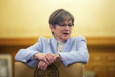 Democratic Kansas Gov. Kelly urges civility; Kobach is AG
