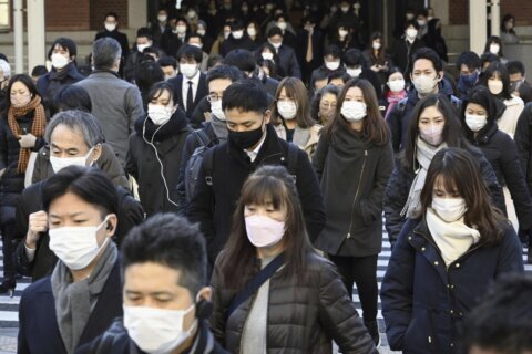 Japan to lower COVID-19 to flu status, further easing rules