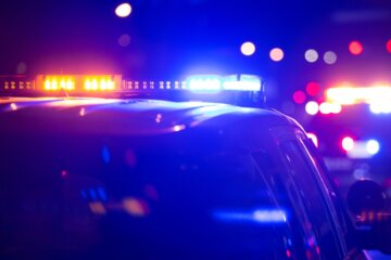 Flashing red and blue lights on top of a police car