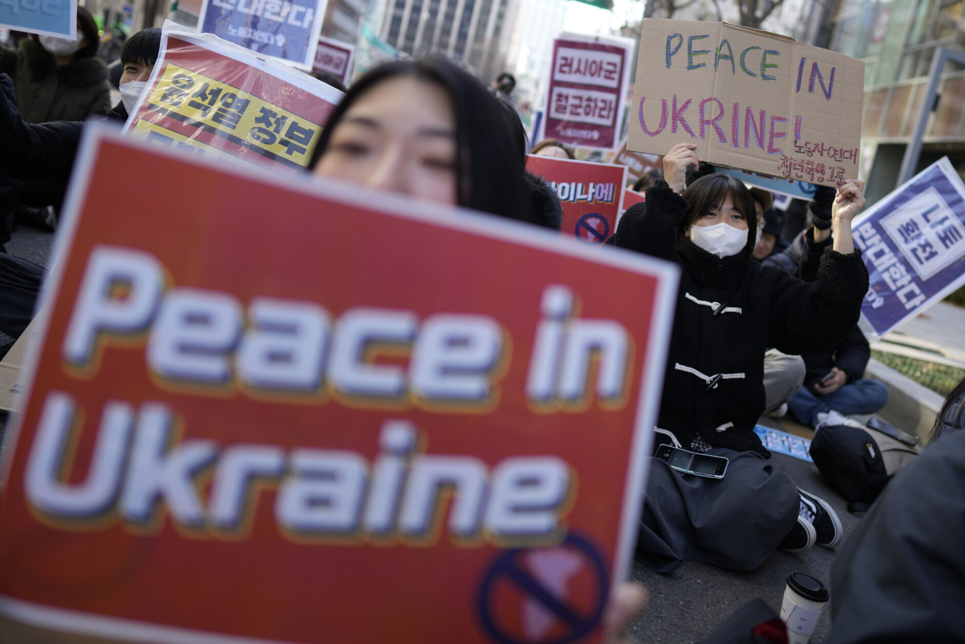 Protesters shout slogans during a rally to mark the one-year anniversary of Russia's invasion of Ukraine, in downtown Seoul, South Korea, Saturday, Feb. 25, 2023. (AP Photo/Lee Jin-man)
